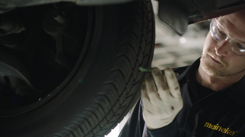 Mechanic checking tire